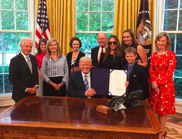 Comstock photo with smiling Trump in Oval office